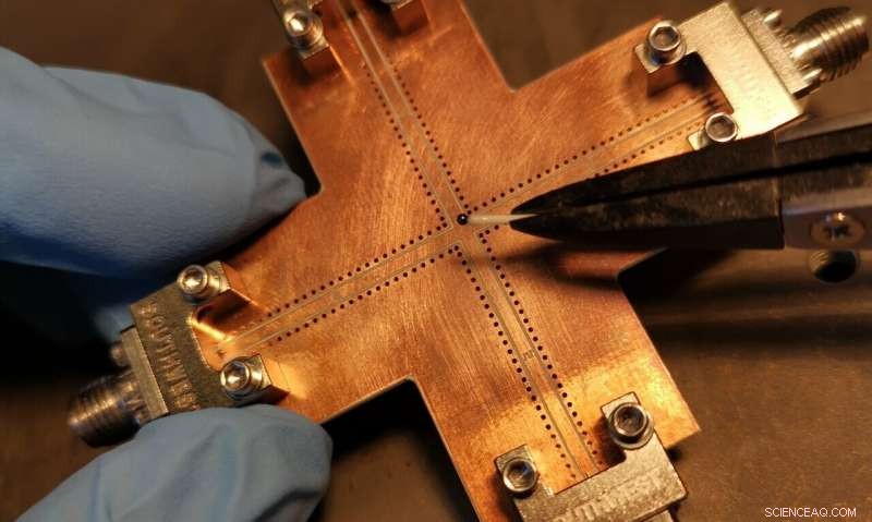 Engineering Dissipative Coupling to Preserve Coherence in Hybrid Quantum Systems