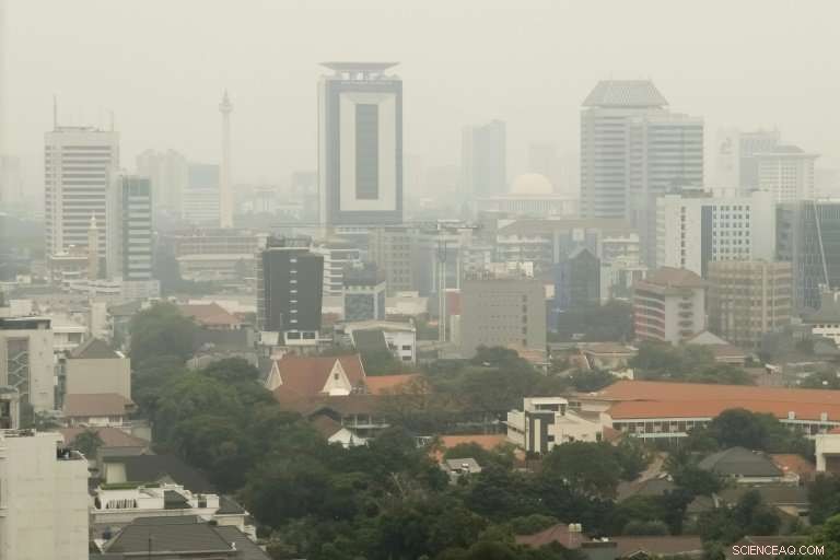 Activists Climb Jakarta Billboard to Spotlight Hazardous Air Pollution Ahead of Asian Games