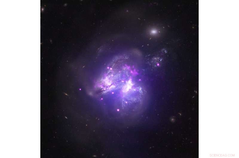 Arp 299: The Cosmic Collision of Two Galaxies