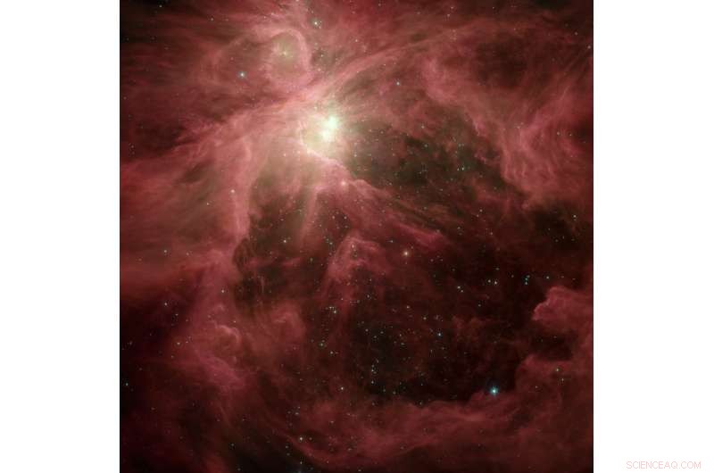 Delocalized Electrons in Defective Hydrocarbons: Unveiling the Source of Cosmic Infrared Emission