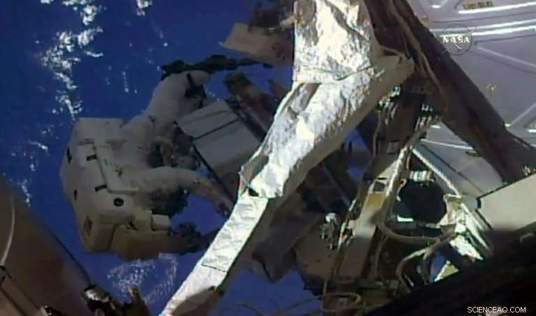 NASA Astronauts Swap and Inspect Cooling Units  Leaky  and  Frosty  During Spacewalk