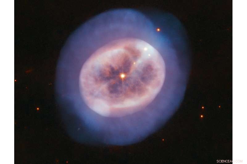 Hubble Unveils Glowing Gas Nebula Around Star NGC 2022