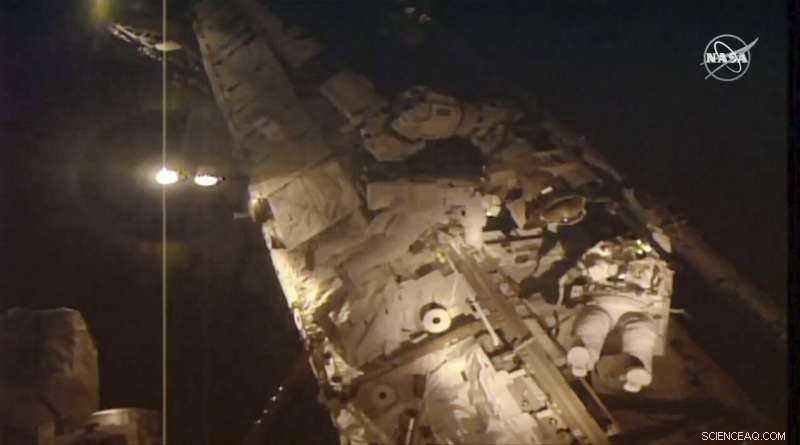 Spacewalking Astronauts Near Completion of Cosmic Ray Detector Repair