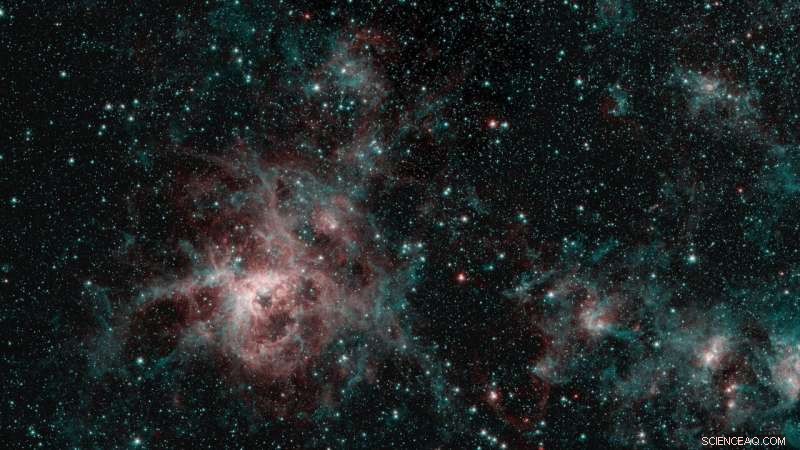 Spitzer Reveals Tarantula Nebula’s Infrared Secrets: Hot Gas & Interstellar Dust
