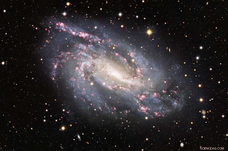 NGC 925: A Glowing Spiral Galaxy Revealing Stellar Birth in Red Clouds