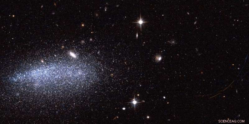 Hubble Reveals Dwarf Galaxy AGC111977 and Two Asteroids in New Image