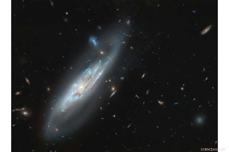 Hubble Captures Stunning Detail of Ghostly Spiral Galaxy NGC 4848