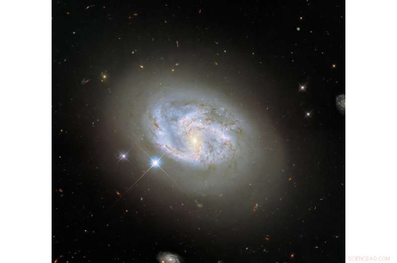 Hubble Captures Spiral Galaxy NGC 4680 Amidst Neighboring Galaxies