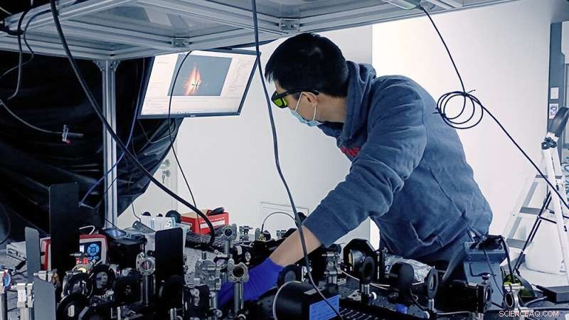 Light-Induced Electron Steering in Graphene Reveals Valley-Selective Hall Effect