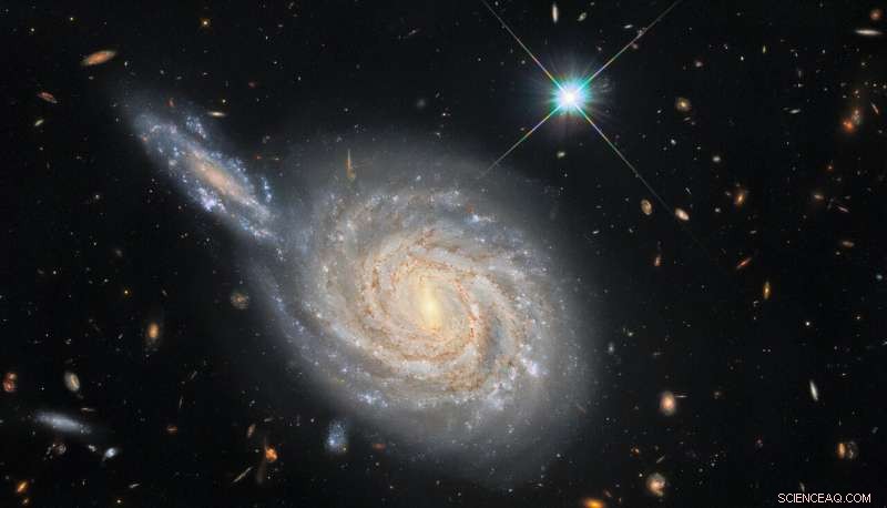 Hubble Reveals Hidden Clues in Spiral Galaxy NGC 105 and Its Neighboring Companion