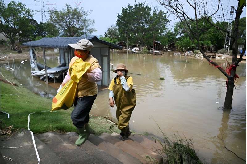 China Floods: Residents Salvage Property Amidst Warnings of Further Rain