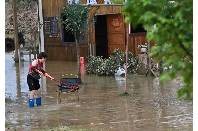 China Floods: Residents Salvage Property Amidst Warnings of Further Rain