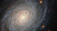 Hubble Reveals Serene Spiral Galaxy with a Turbulent Past